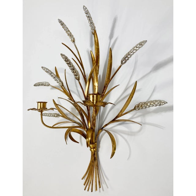 Classic large gilt metal Italian Tole sheaf of wheat wall sconce featuring two candle holders. Plumes tipped with silver....