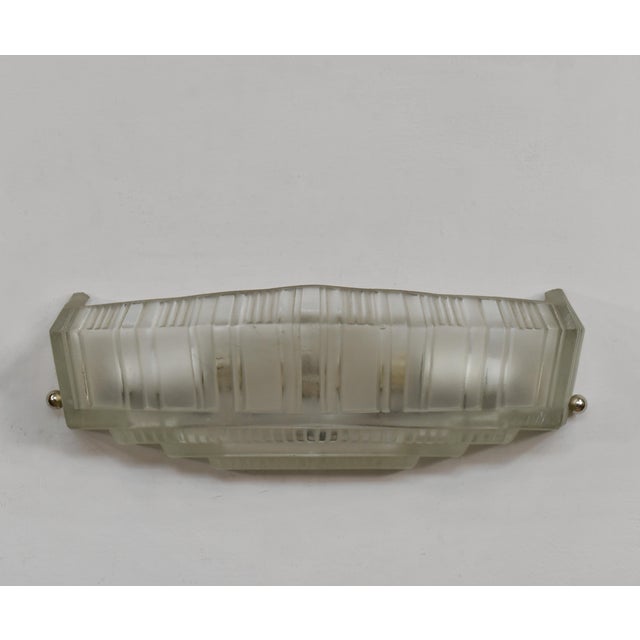 Genet et Michon An extremely rare pair of French art deco wall sconces in clear frosted molded-pressed glass. Made circa...