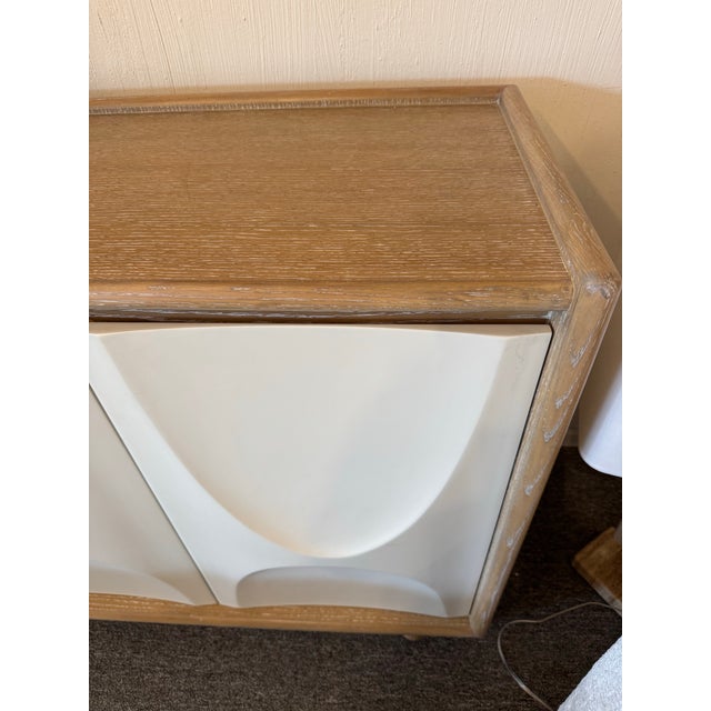 Five deeply sculpted hardwood doors have the feel of plaster, with a milk-color lacquer finish. Three compartments each...