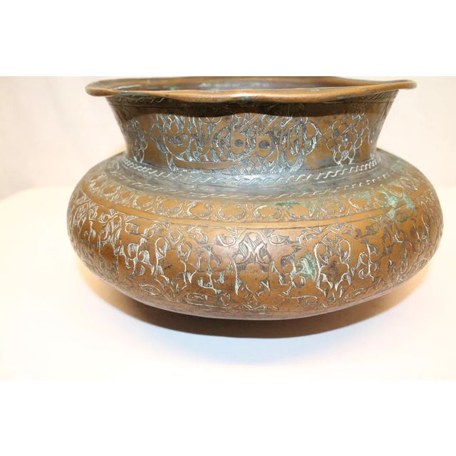 Very old antique copper bowl, urn, which we estimate to be from the 18th Century, with intricate carvings including what...