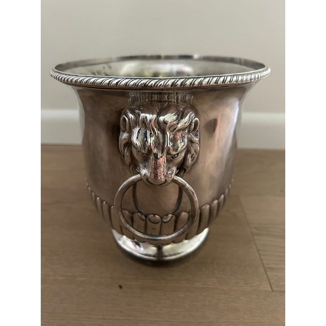 Beautiful silver urn with lion head handles . This has a footed bottom and loads of interesting details. The interior show...
