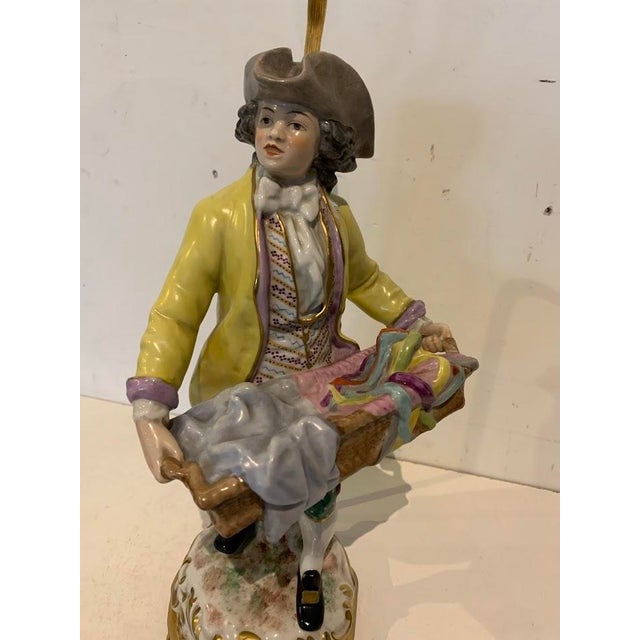 Polychrome porcelain group mounted as a lamp "young man with a basket" brass base and light stem very good condition...
