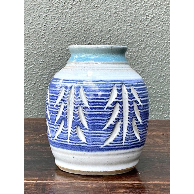 This vintage handcrafted ceramic vase is a beautiful expression of artisanal pottery, featuring an intricately hand-carved...