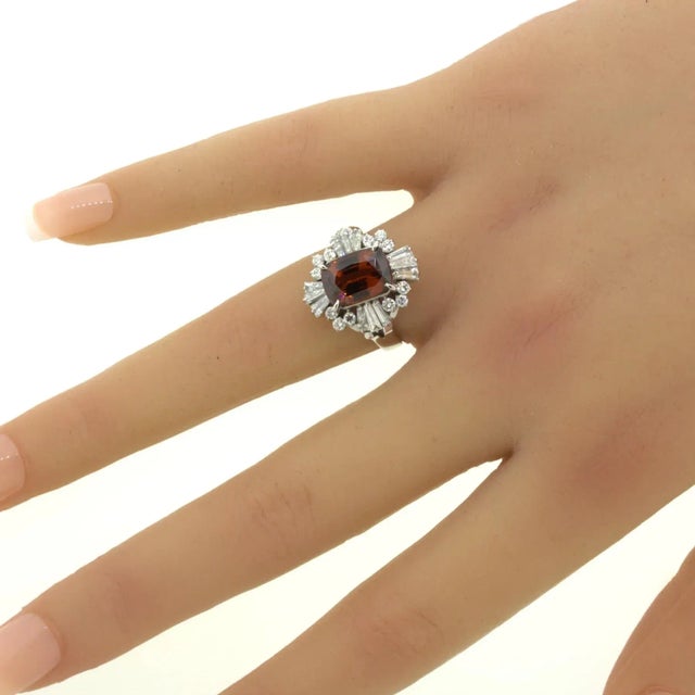 A chic and elegant platinum ring! It features a beautiful zircon weighing 5.21 carats with a unique golden-orange color....