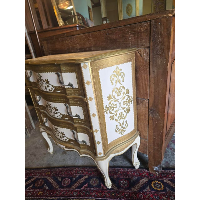 Authentic 1940s Venetian chest of drawers, hand-painted in an ivory finish with elegant gilt decorative detailing...