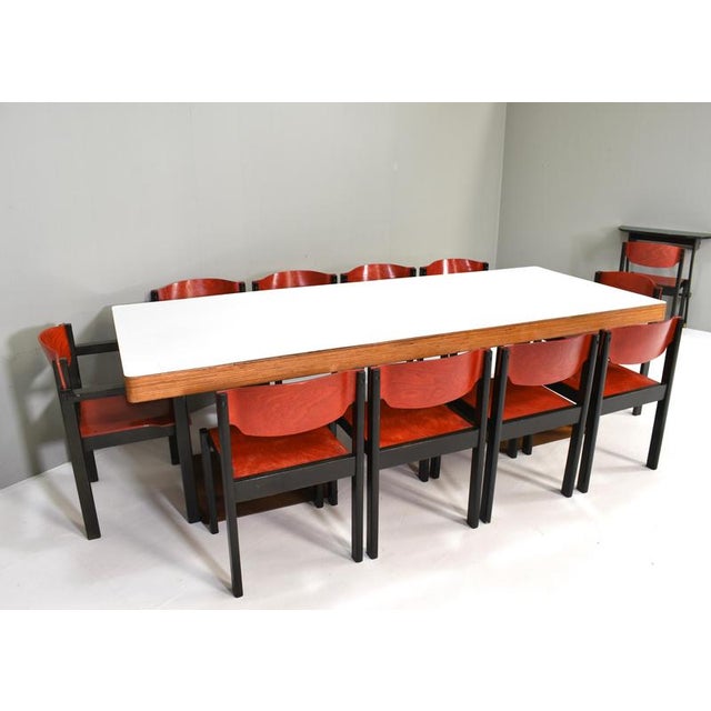 Set of 14 dining chairs in stained solid beech and bent plywood. 12 regular chairs and 2 armchairs. The last image is an...