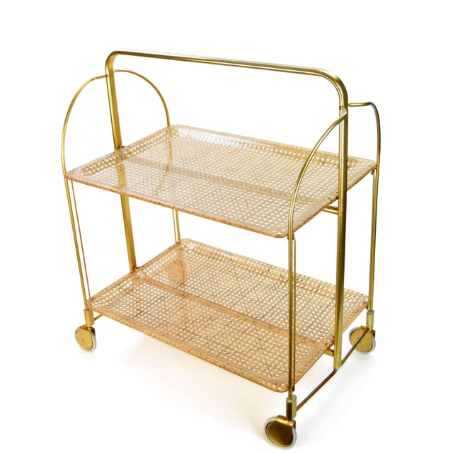 Serving trolley, made in the mid-20th century. An interesting folding trolley with a gold-tone metal frame and acrylic...