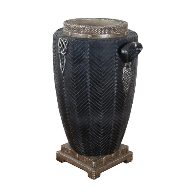 Vintage composite / resin floor vase in the shape of a trophy urn on a light bronze colored, square, tiered base and...