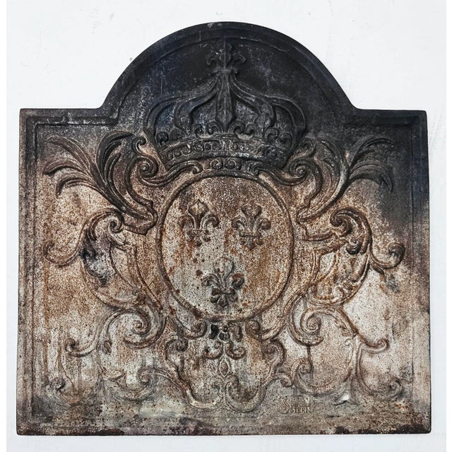 Beautiful antique French fireback with the arms of France. The coat of arms consists of a crown with three Fleurs-de-Lys...