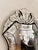 Venetian-style mirror featuring an elaborate sculptural crest, graceful scrolling details, and delicate floral etching...