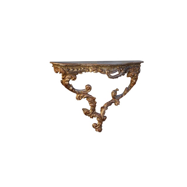 A stunning hand-carved wood champagne gilt finish Italian style wall-mount console table. Beautiful carved detailing -...