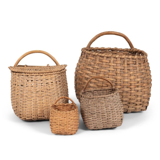 A collection of four 19th-century Swedish baskets in varying sizes, handcrafted from woven splints of split willow and...
