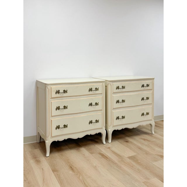 This charming pair of vintage French Provincial three drawer chests are a beautifully detailed and versatile bedroom and...