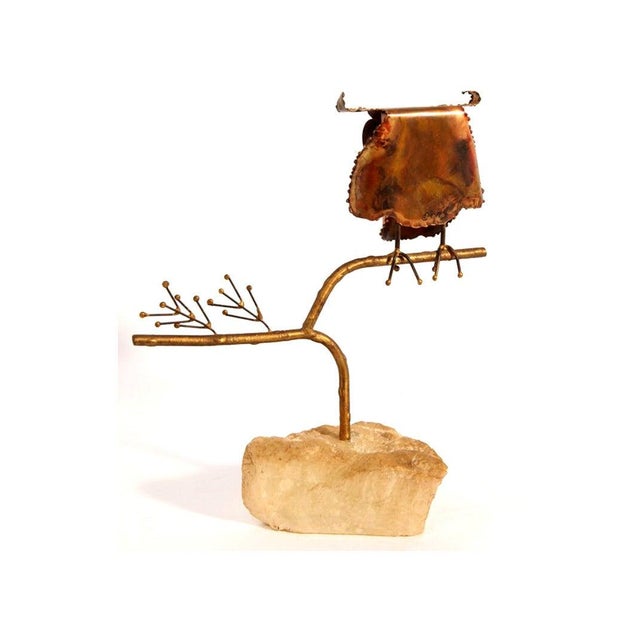 A small but sweet table top sculpture by C. Jere circa 1967. Made of brass with enamel eyes and installed on a natural...