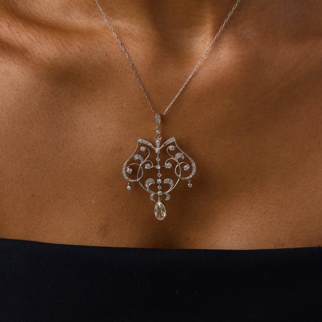 This extraordinary Edwardian pendant necklace is a richly detailed jewel from the 1910’s, centered by an antique pear...
