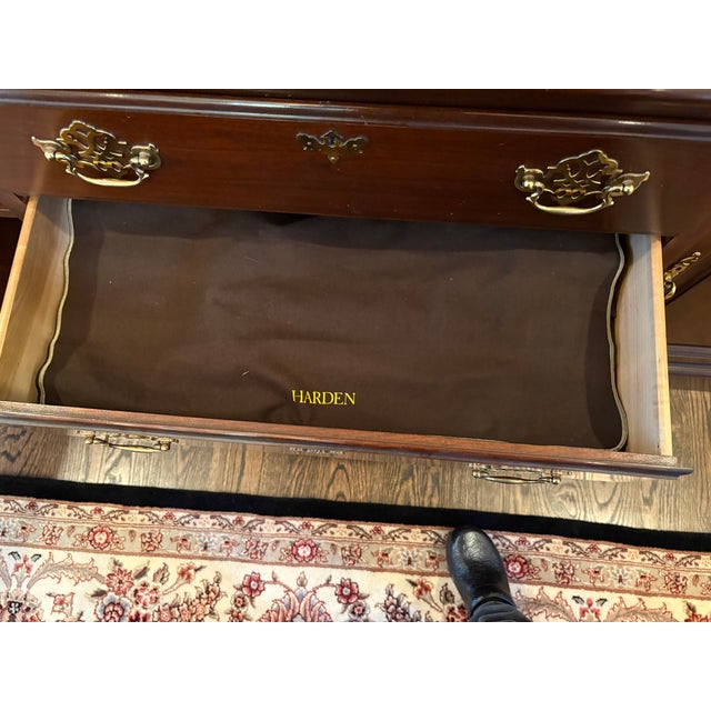 We purchased this breakfront in 1995 when we moved into a new house. We are the first and only owners. It's mahogany and...