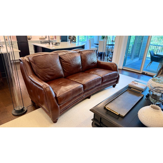 Elevate your living space with this exquisite luxury leather sofa crafted by the renowned high-end maker Hancock & Moore....