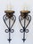 Impressive pair of painted wrought iron and gilded metal Spanish Revival style wall sconces. The sconces have elegant...