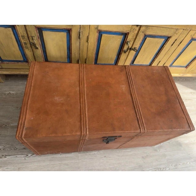 This Antique Anglo-Indian Leather Campaign Trunk is a stylish and timeless piece of furniture that exudes a classic charm....