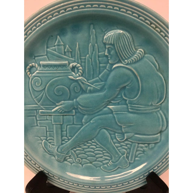 Interesting decorator plate carving of an artist painting his work. Looks like the mid evil era. No defects and the aqua...