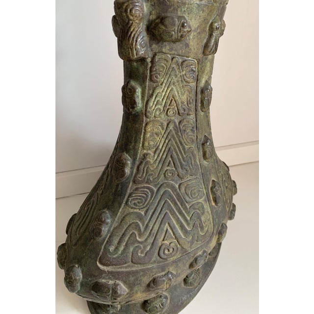 Of Classic vessel form, with an oval, splayed foot, narrow, waisted body and wide, flaring mouth. Very heavy and archaist...