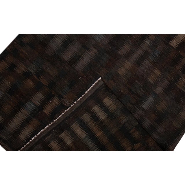 Beautiful modern Kilim hand-knotted wool rug with a black field. This piece has multi-color accents in an all-over...
