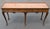 This exceptional console table attributed to Baker Furniture beautifully showcases the timeless elegance of classic Queen...