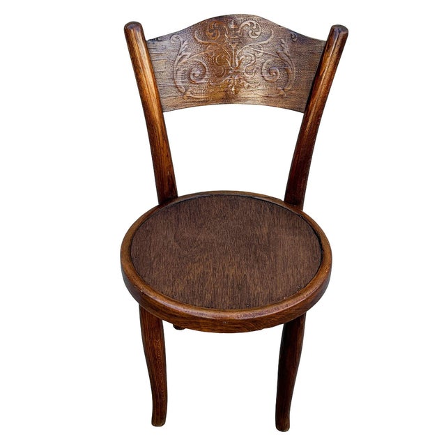 Victorian sculpted oak side chair with a carved Backrest by Jacob & Josef Kohn featuring an elegant, sculptural frame...