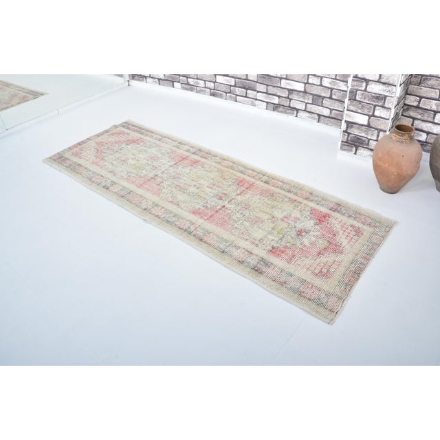 This is a vintage Turkish nomadic wool rug. The piece was handmade in the 1960s.