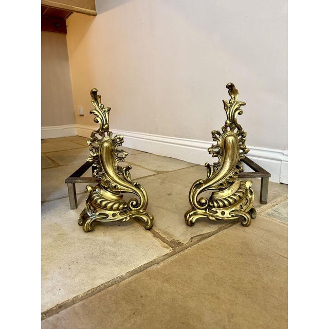Large pair of antique French brass rococo fire dogs, having a quality large pair of French brass Rococo andiron Chenets of...