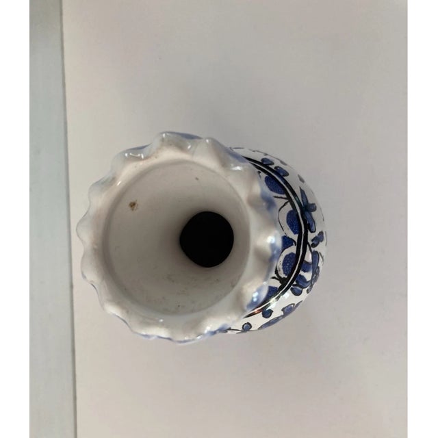 Graceful baluster or flared form with a glossy majolica-style glaze, entirely hand-painted in a rich polychrome palette....