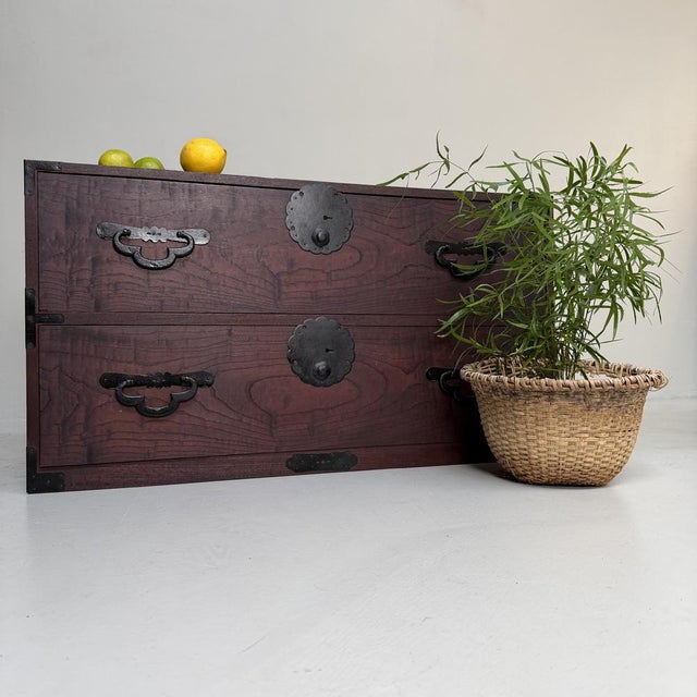 A sober, powerful Japanese kimono tansu from the Meiji period, originally made for storing kimono and textiles. This low...