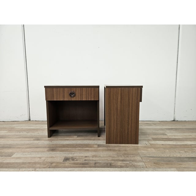 A charming pair of bedside tables dating back to the 1960s, featuring a minimalist and functional design typical of period...
