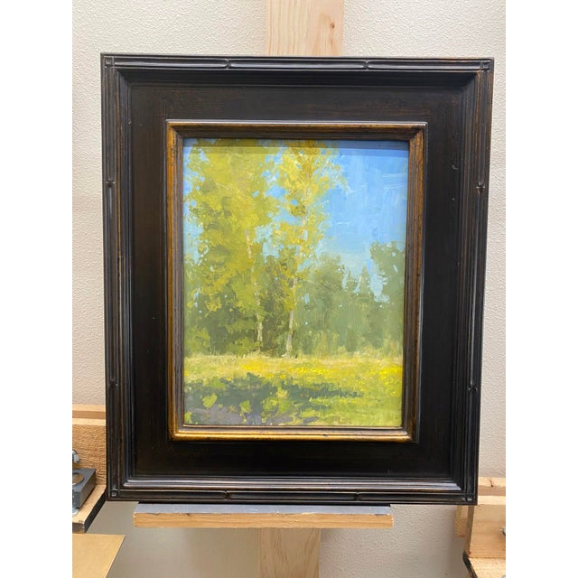 Birch Meadow captures a serene landscape where slender birch trees rise against a soft blue sky, their golden leaves...