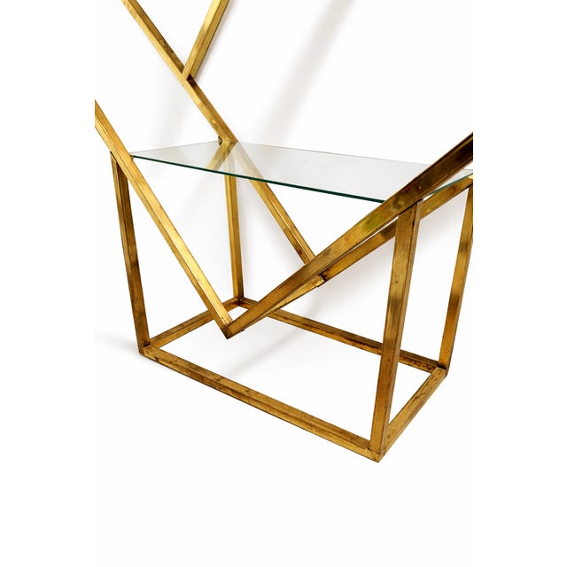 DESCRIPTION Bold, architectural, and unapologetically sculptural. This striking geometric étagère features a brass-...