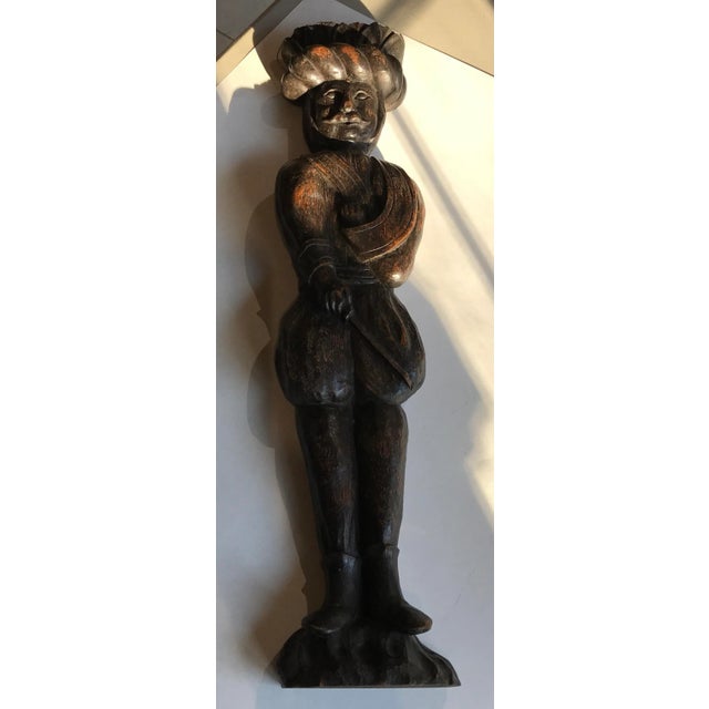 Unusaul wall hanging made from possibly a fragment from a wall or even a piece of furniture. charming soldier with his...