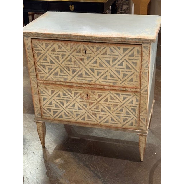 Decorative pair of hand painted Neo-Classical style beside tables from Germany, featuring a nice geo-metric pattern....