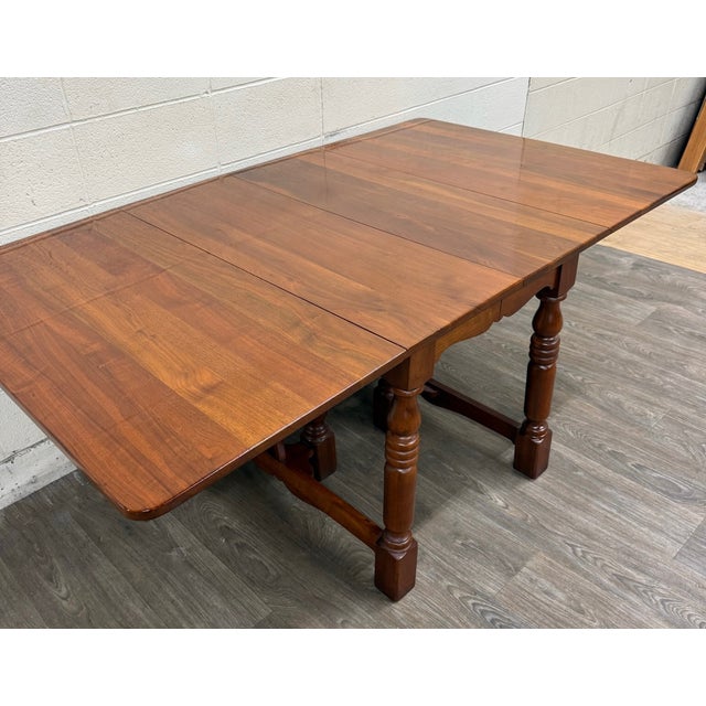 This is a stunning vintage Early American, Colonial Revival, Jacobean, or William and Mary style walnut dining table...
