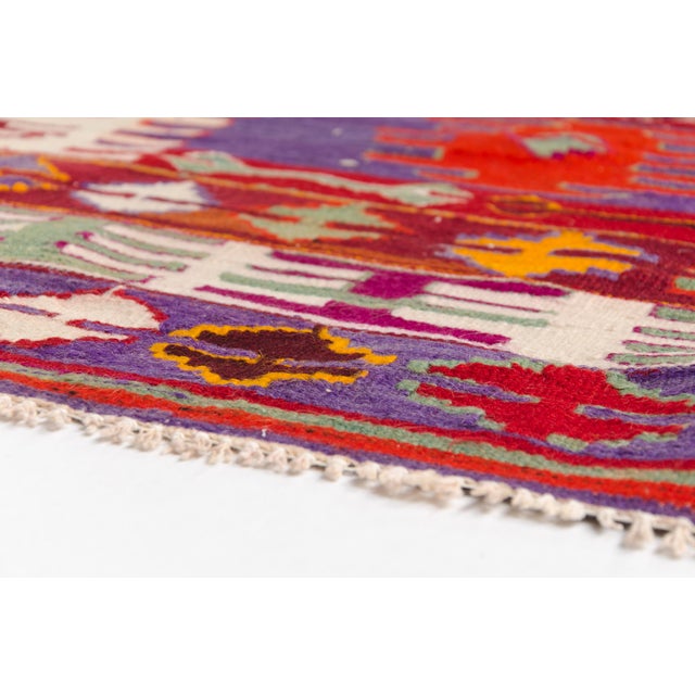 This is a vintage Turkish Oushak rug from the Mid 20th Century. The piece was hand-knotted.