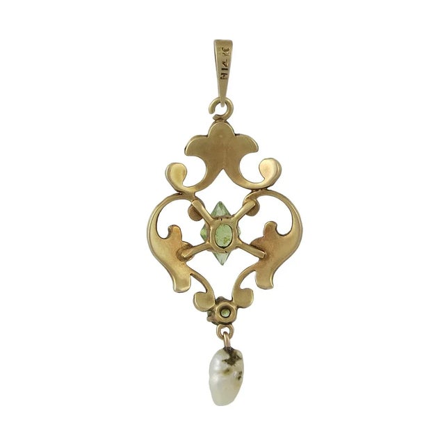 A wonderful early Krementz 14K gold, seed pearl and peridot lavalier with a freshwater pearl drop. Even the bale has tiny...