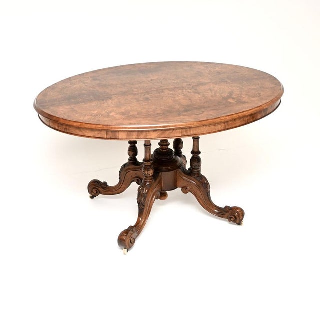 A magnificent antique Victorian inlaid burr walnut loo table, with a lovely shape and bold carving on the base. This was...