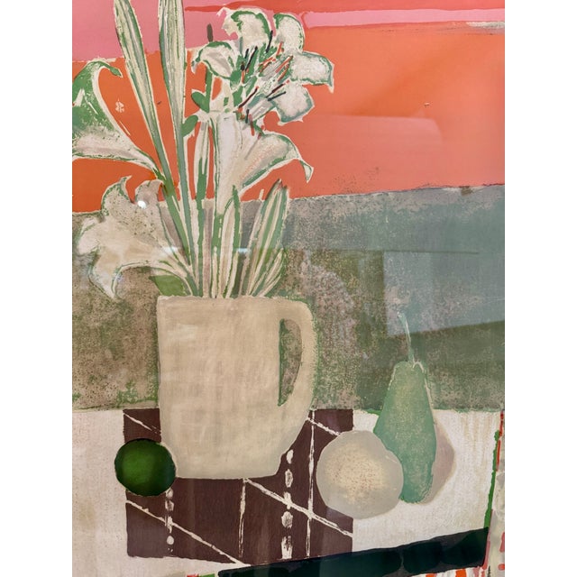 Bold and decorative mid-century color print depicting a still life with white lilies in a white pitcher, a pear, round...