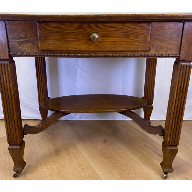 This vintage oak side table is a beautifully crafted piece that blends traditional design with practical functionality,...