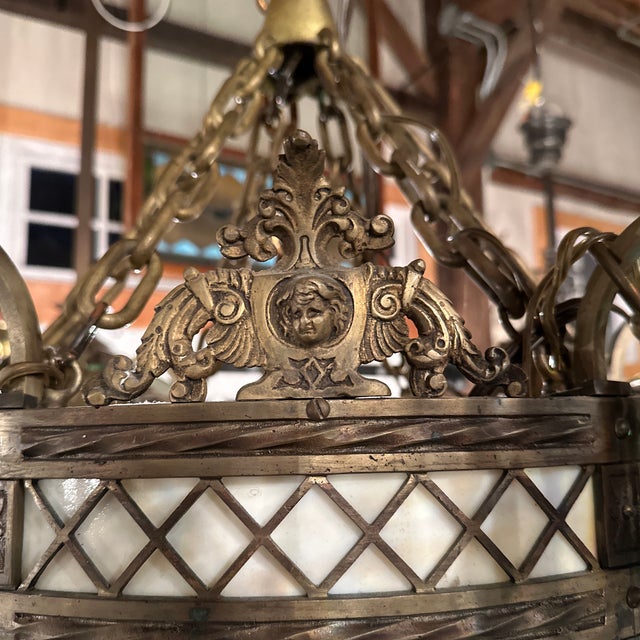 Old Lights On is pleased to offer this large vintage brass seven light hanging fixture with leaded panels. Wired and ready...