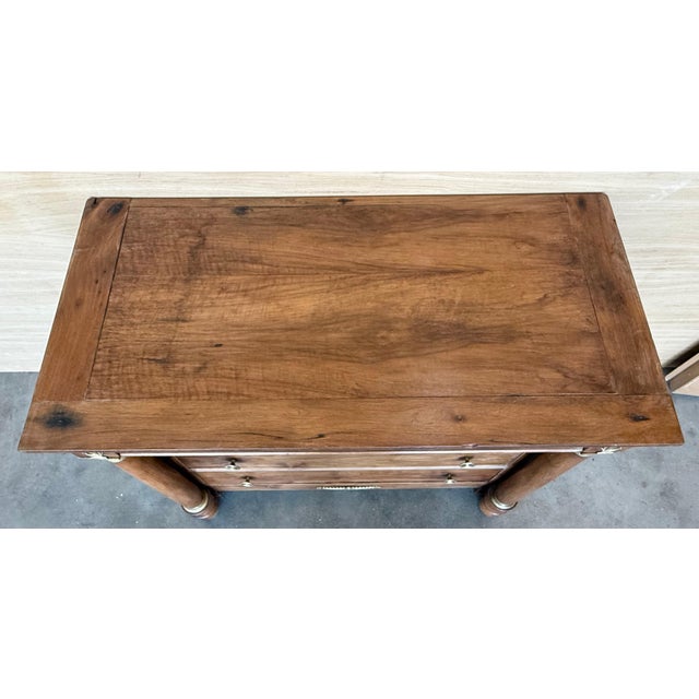 1830s French Empire walnut chest with four drawers and gilded edges Beautiful wooden root.