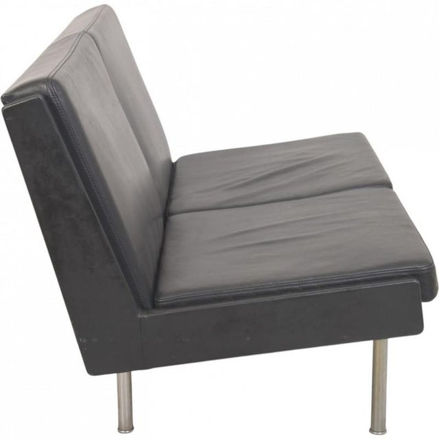 Hans wegner ap35 2.seater sofa upholstered in black leather and with steel legs. The sofa is from the 1970s and appears in...
