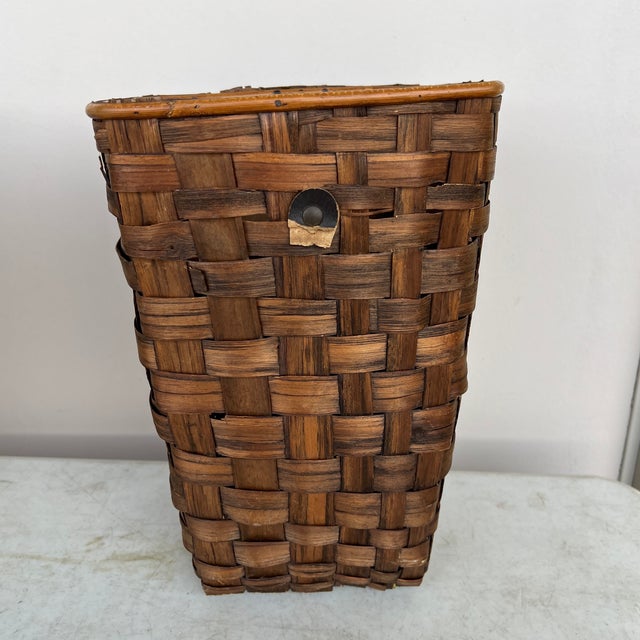 Vintage basket made from woven palm tree leaves. Made in Hong Kong. Has little metal feet. Estate item from a house...