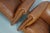 This pair of cognac-colored leather club chairs come from the Netherlands. They are upholstered with cognac-colored...