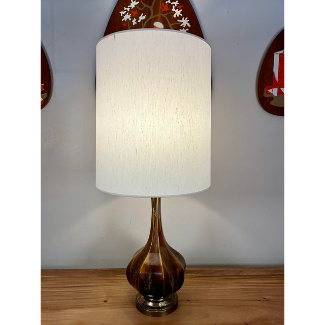 Beautiful glazed mid century lamp sitting atop a brass base. Included lamp shade is in very nice vintage condition and...