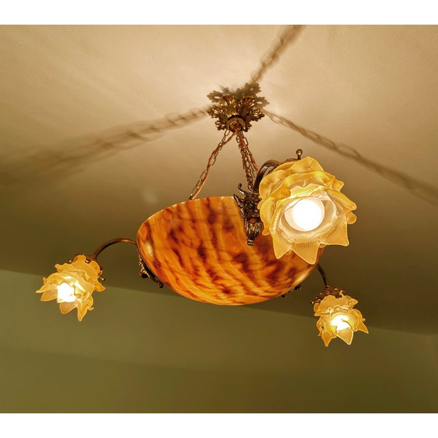 Italian art deco pendant light featuring an honey marroon agate alabaster bowl with bronze satyr mount paired with three...